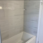 deep bathroom tub with large tiles