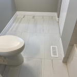 bathroom toilet with large tiled floor