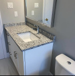 bathroom vanity with granite countertop and recessed sink