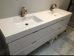 bathroom with dual recessed vanity sinks
