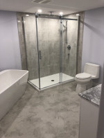 bathroom with freestanding tub and walk-in shower with glass doors