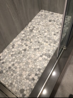 bathroom shower with pebble tiles