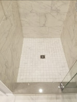 bathroom shower with tiled walls and floor