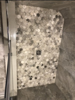 bathroom shower floor with hexagonal tiles and center drain