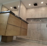 bathroom with wood vanity and marble tiles