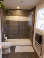bathroom with walk-in show and sliding glass doors