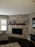 family room with floor-to-ceiling brick fireplace and wood mantel and wood flooring