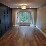 wood flooring in a family room with bay window