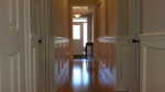 hallway entrance with white wainscoting and wood flooring