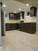 kitchen with tiled floor, dark wood cabinets, and pot lighting