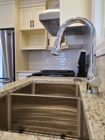 kitchen with granite countertop, twin recessed sinks, and chrome faucet