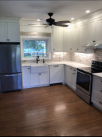 kitchen with wood flooring, white cabinets, and ceiling fan