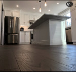 kitchen with wood flooring, center island, and twin pendant lighting