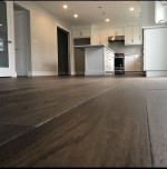 kitchen with medium-dark wood flooring and white cabinets
