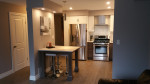 kitchen with breakfast table, wood flooring, and pot lights