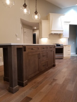kitchen island with storage cabinets on medium-dark wood flooring