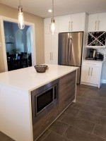 white kitchen island with storage and built-in microwave
