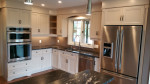 kitchen with white and beige cabinets and stainless steel appliances