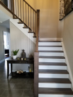 residential stairway entryway with dark wood and white trim