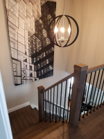 residential stairway landing with spherical chandelier